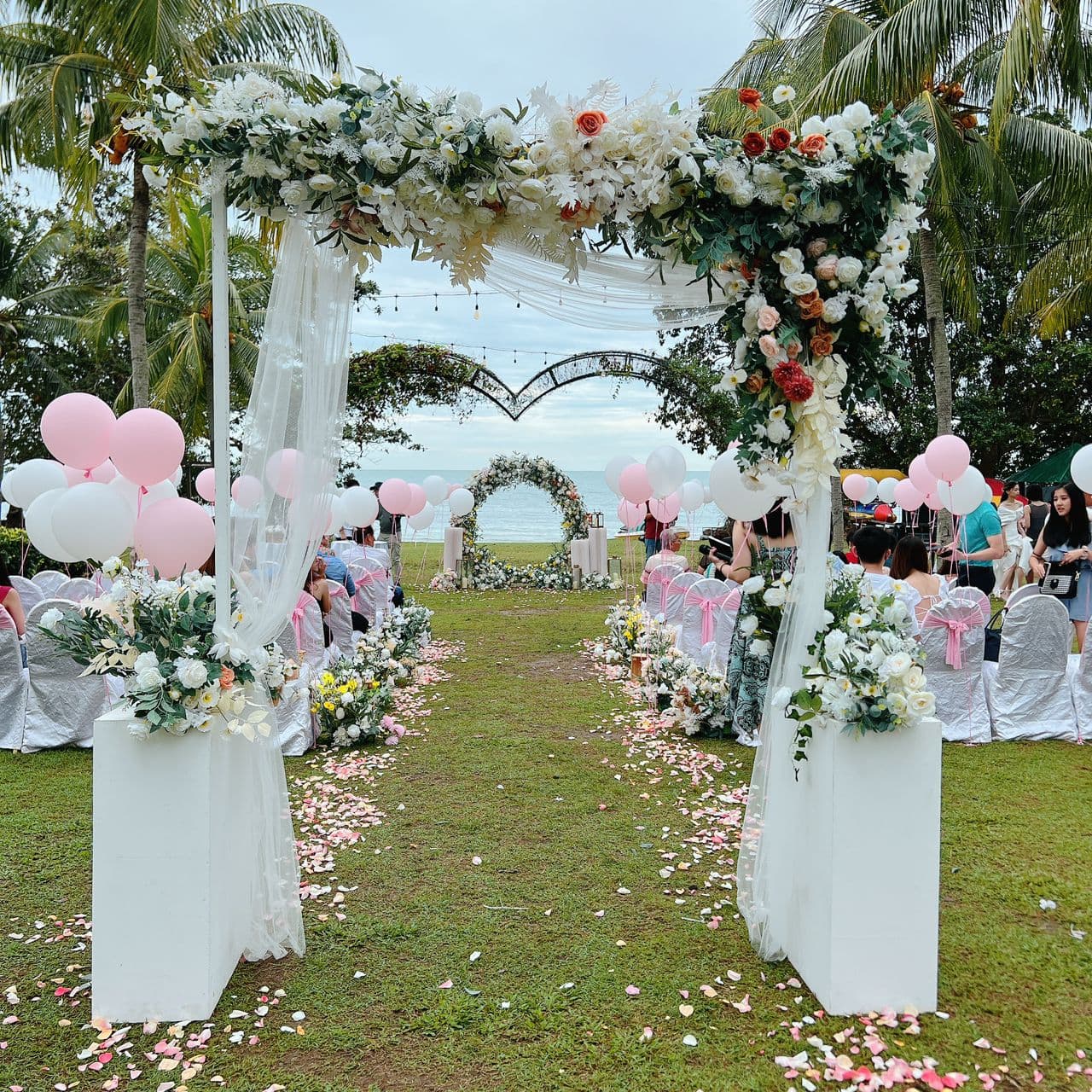 Elegant garden wedding aisle with floral arch styled by Phantasome